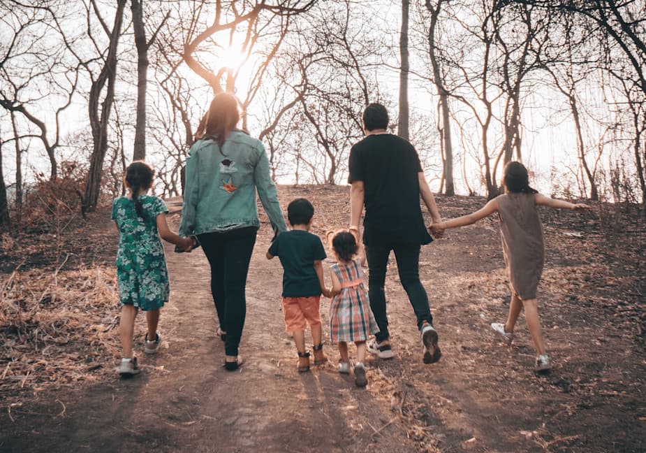 family walking together through burned trees
