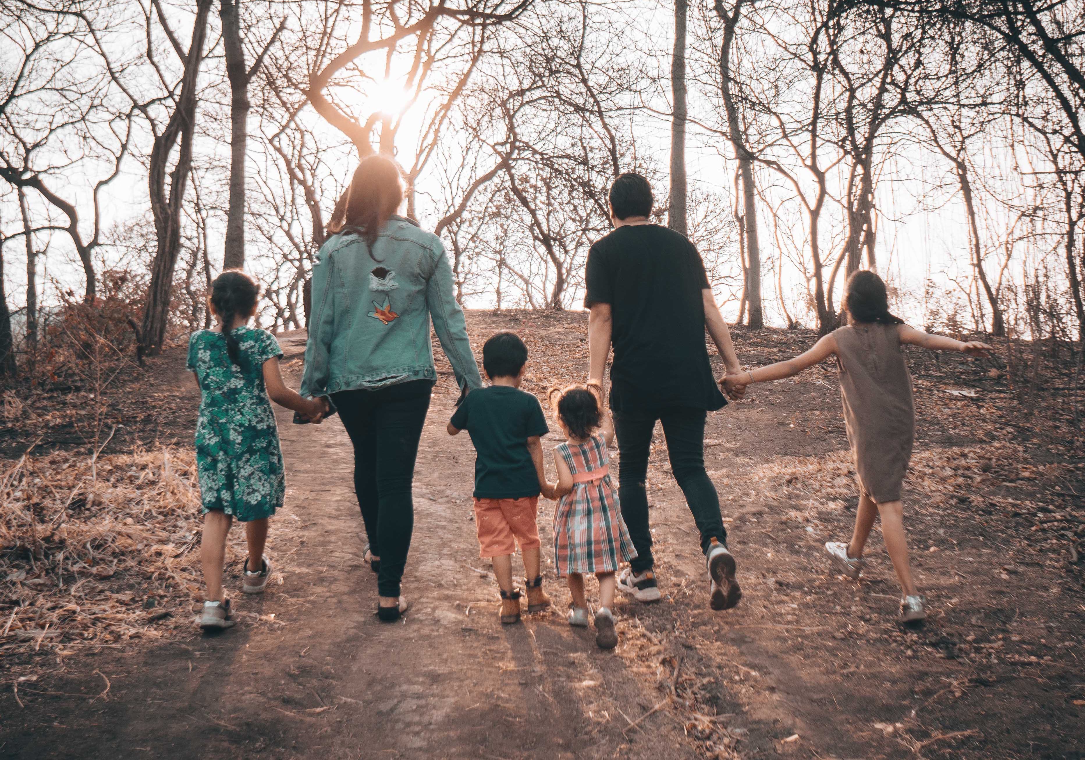 family walking together through burned trees