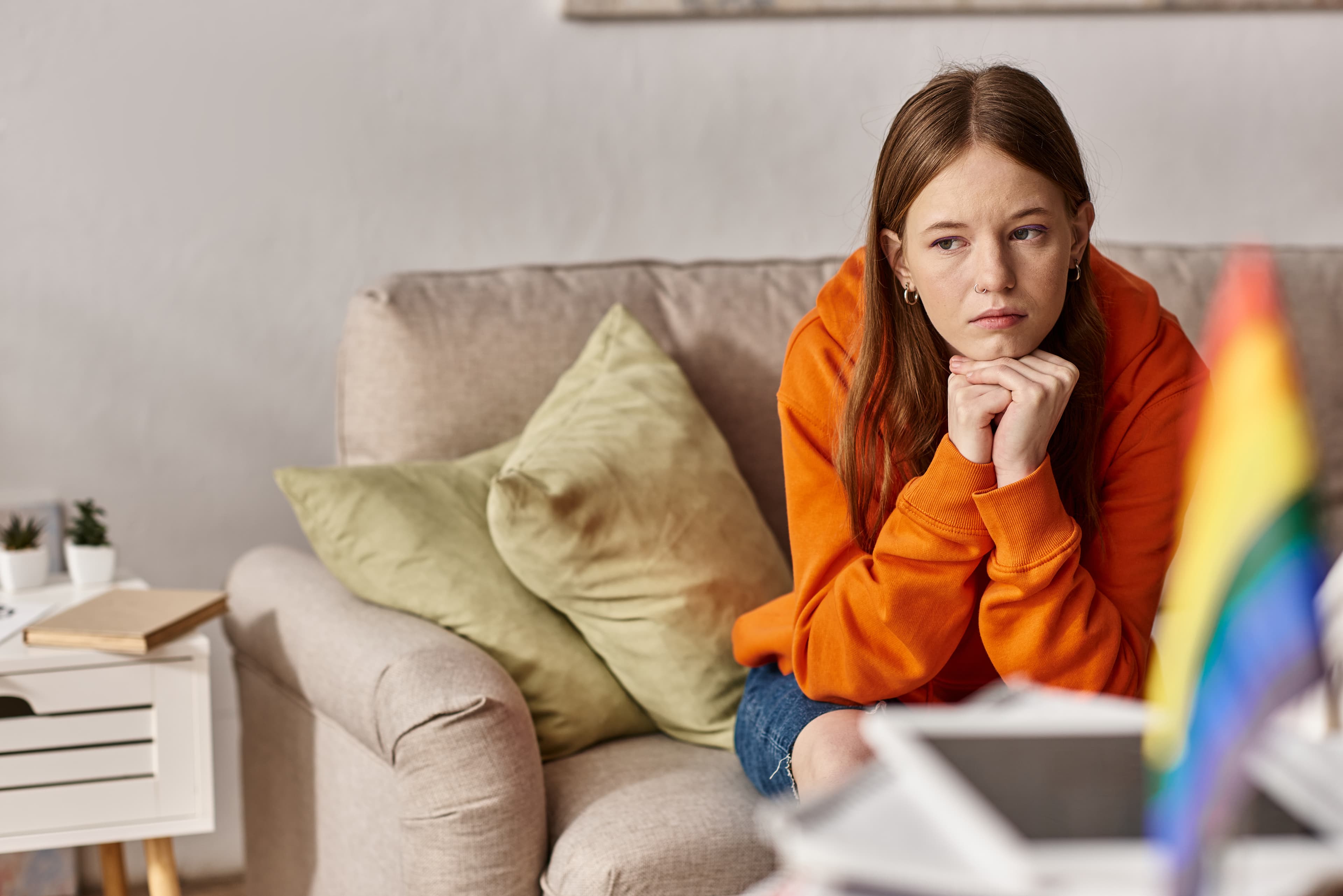 Girl in home with pride flag