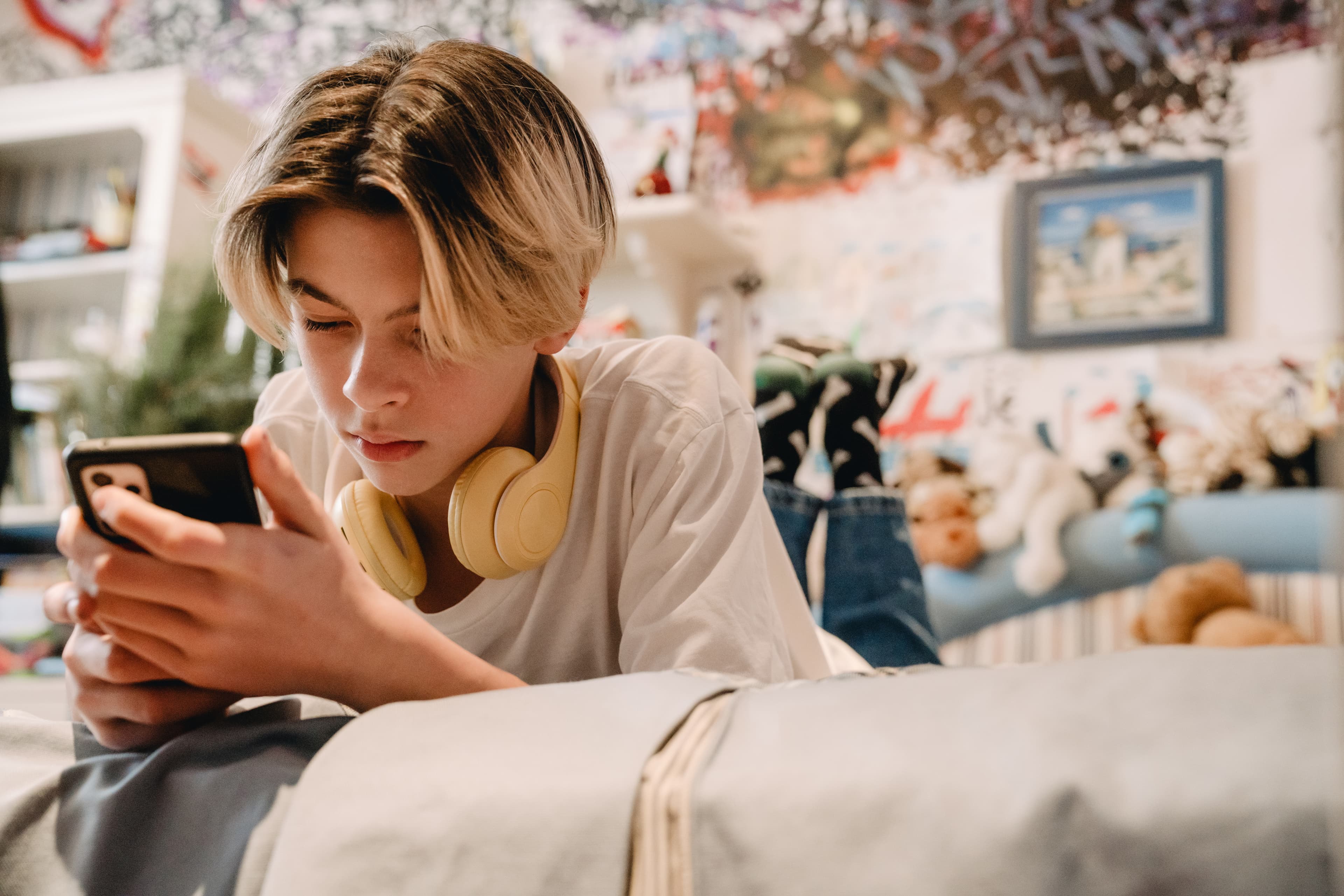 Boy on phone on bed
