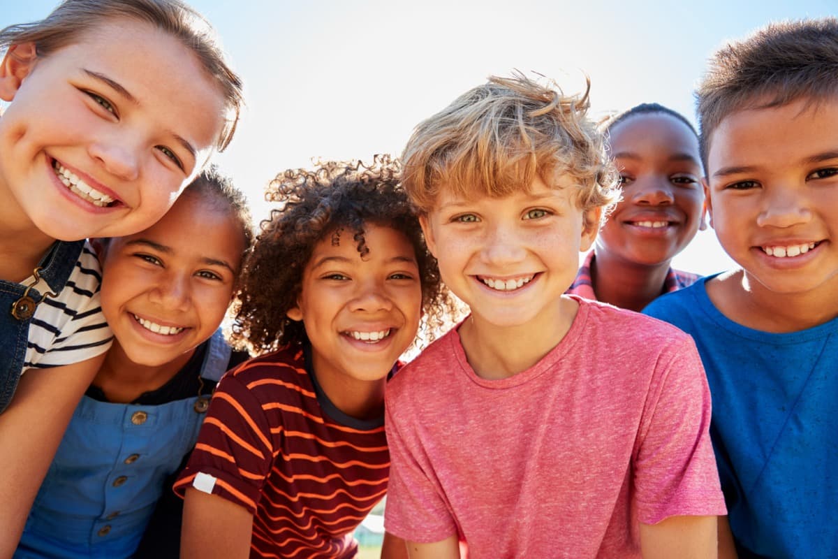 Kids laughing together outdoors in a park