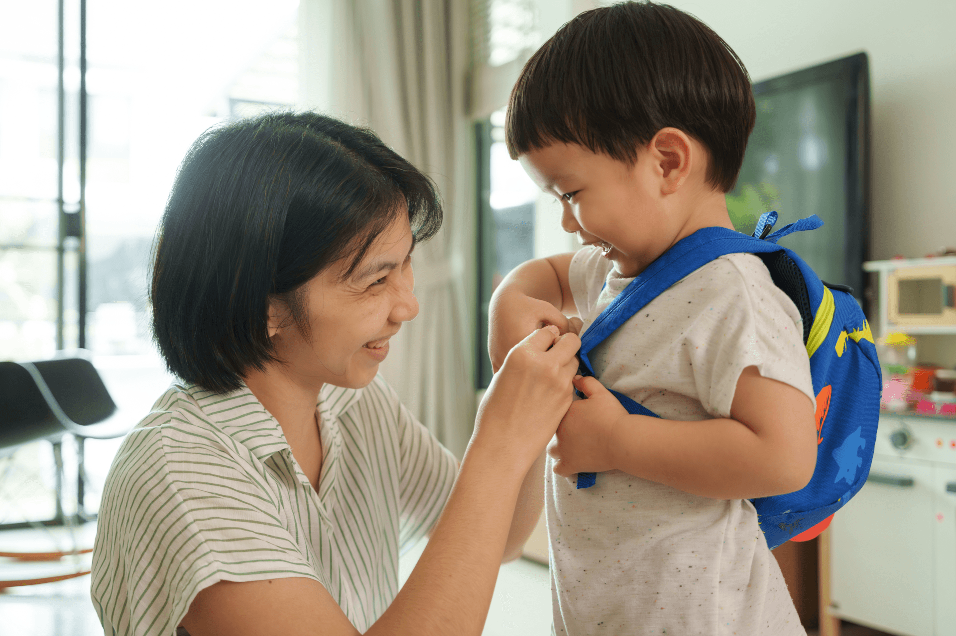 Boy with backpack in home