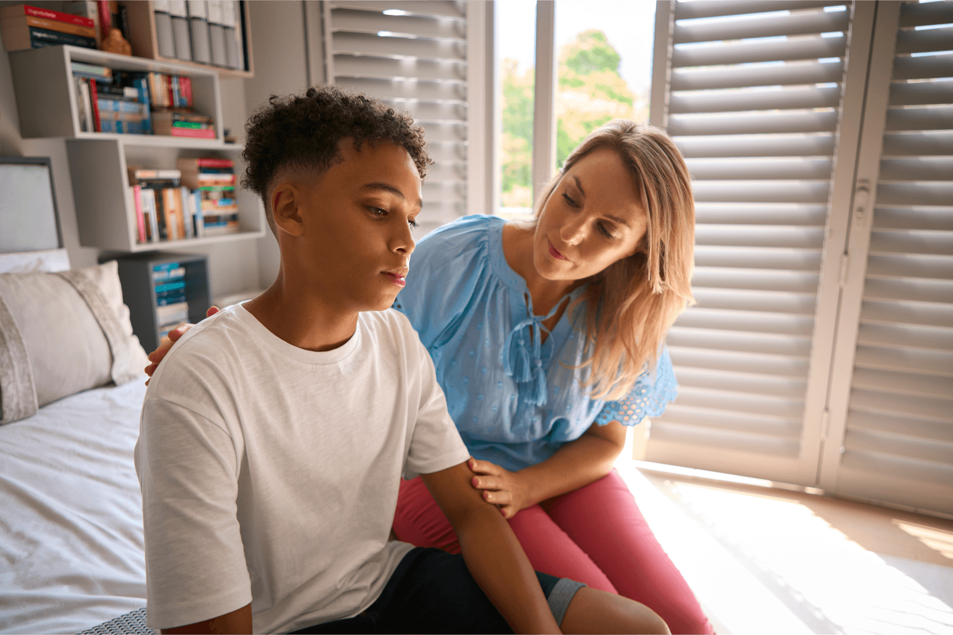 Mom and son talking in his room