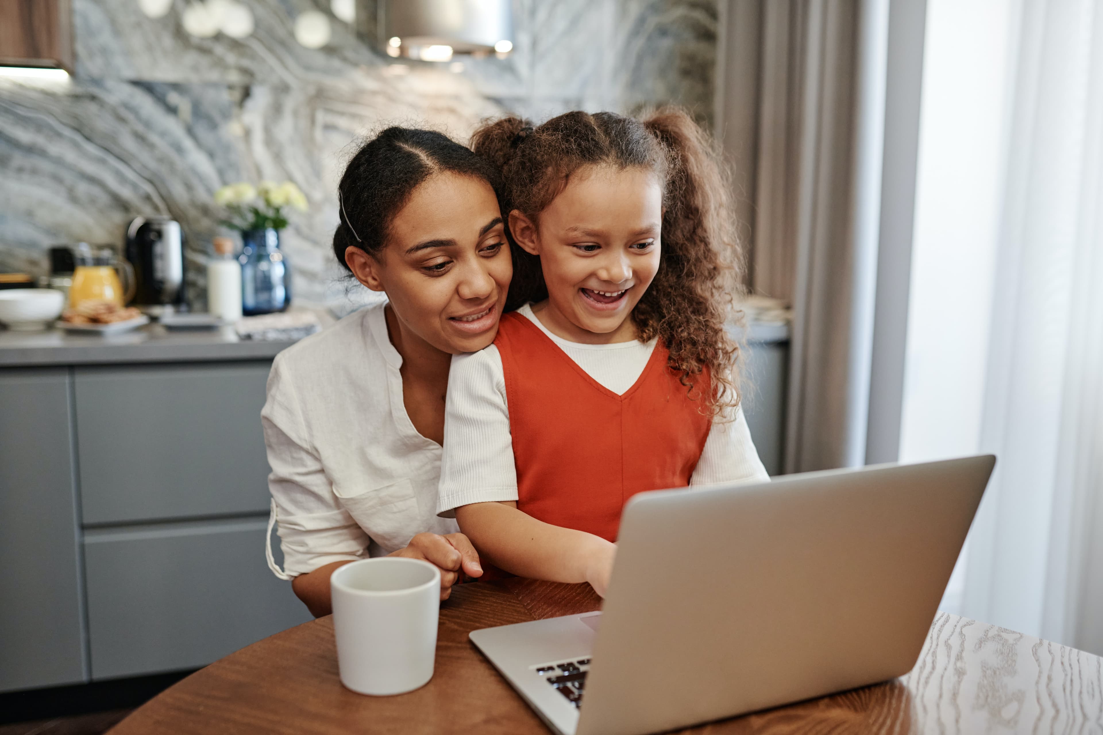 Mom and daughter in front of computer
